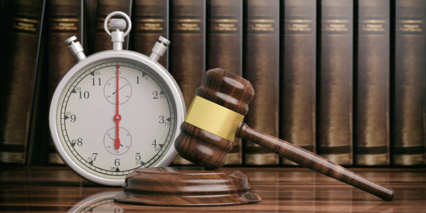 stopwatch next to judge gavel on law books